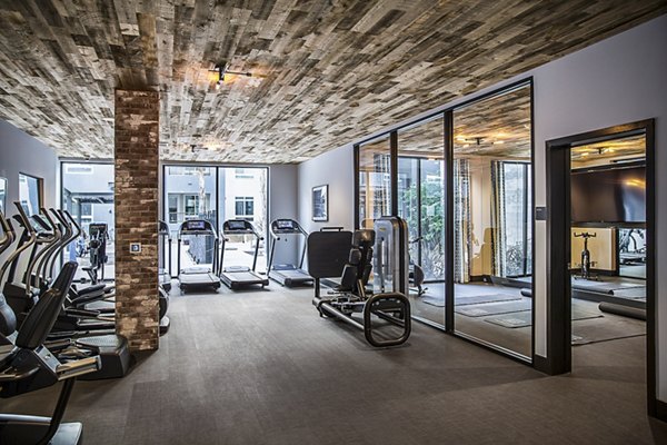 Modern fitness center with state-of-the-art gym equipment at The Griffith Apartments for luxury living in a stylish community