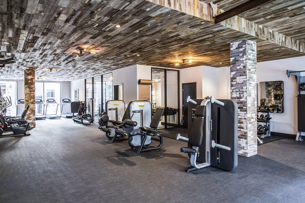 Modern fitness center with state-of-the-art equipment at The Griffith Apartments