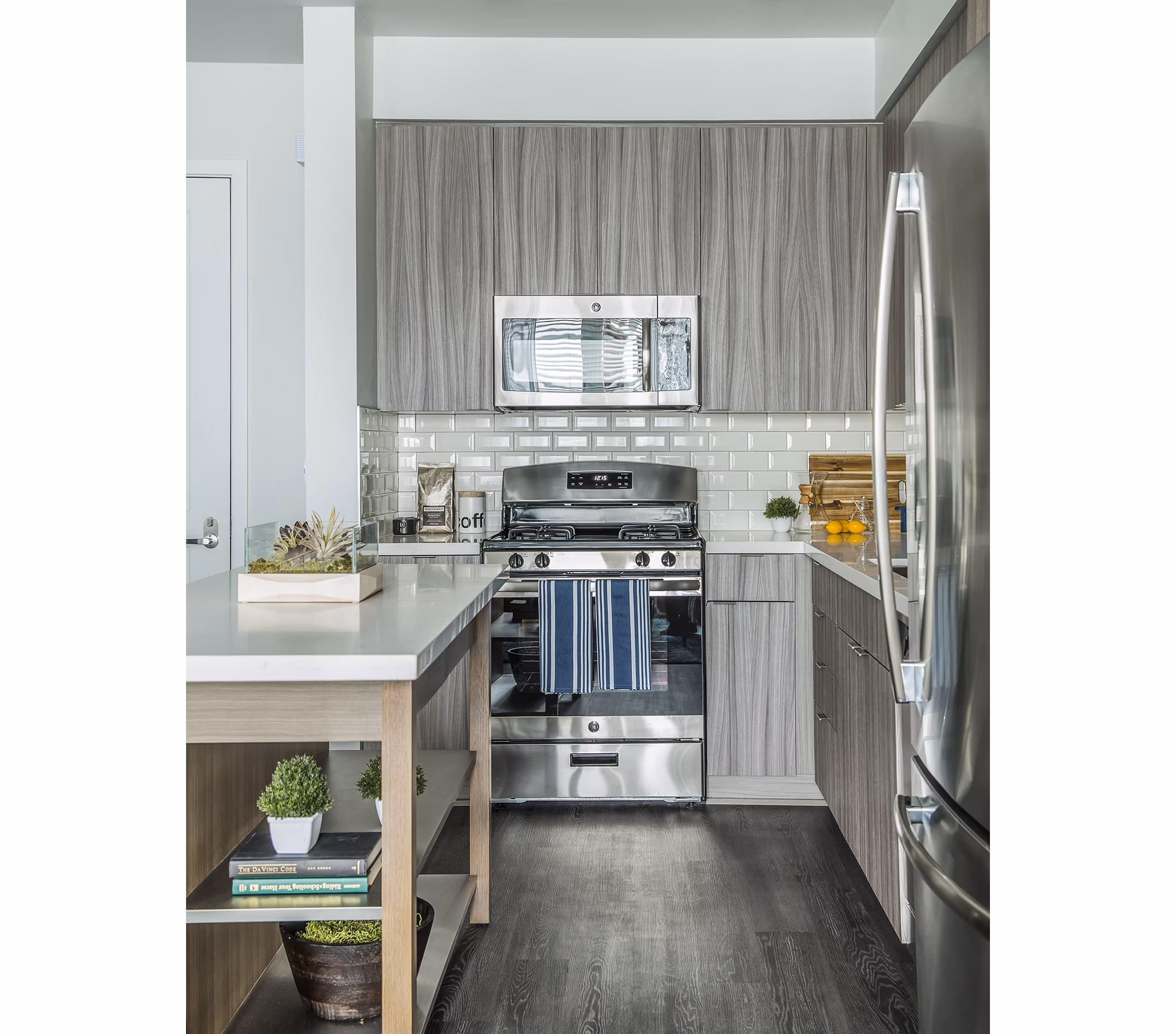 Modern kitchen with sleek countertops and stainless steel appliances at The Griffith Apartments