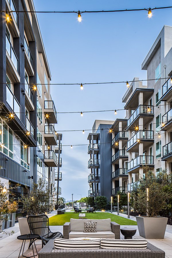 Outdoor sport court at The Griffith Apartments offering residents space for basketball and tennis activities