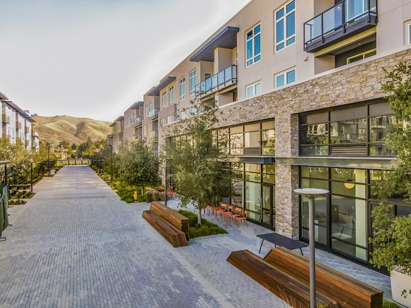 Modern luxury apartment complex with a landscaped courtyard and paved walkway