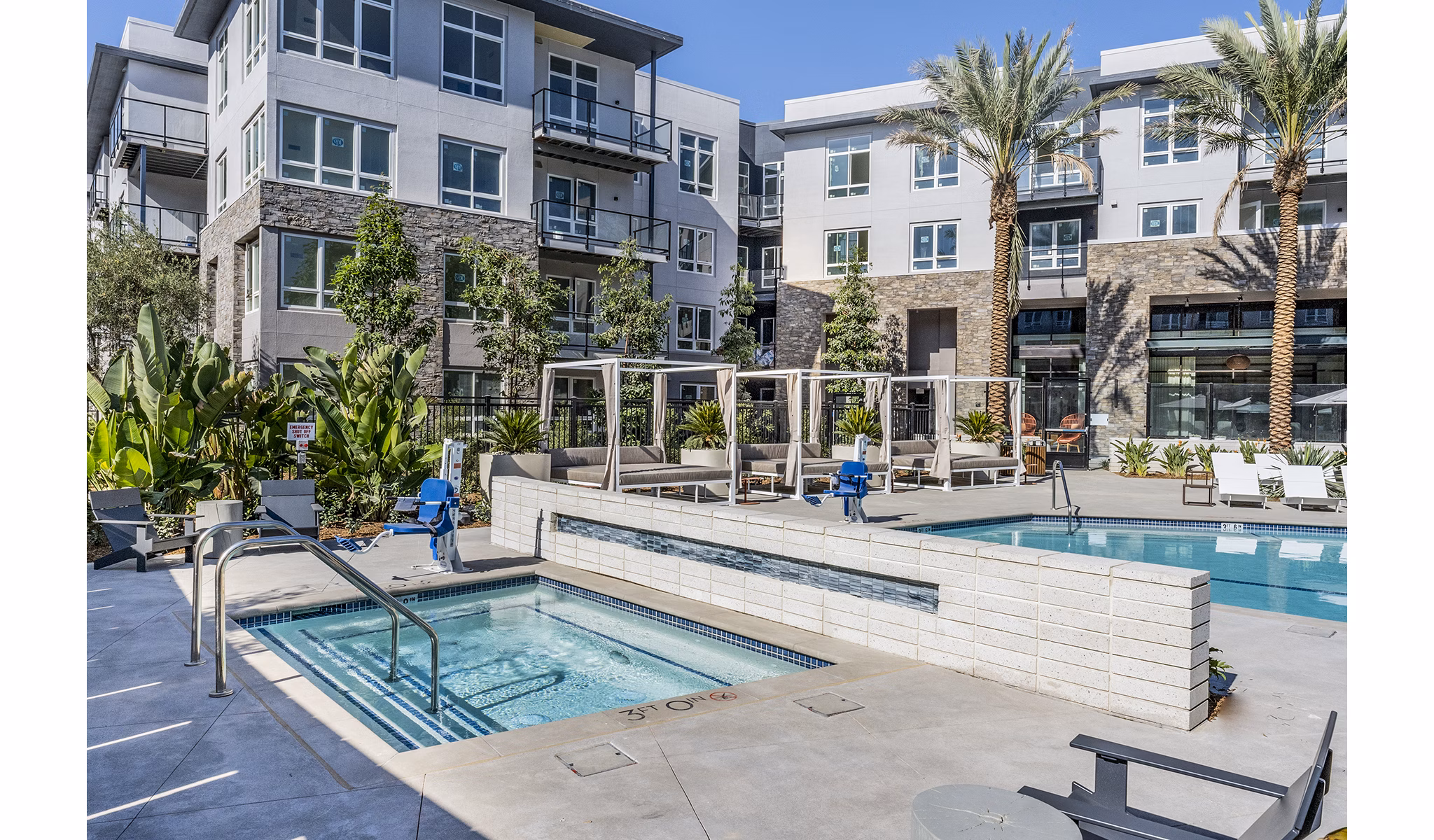 Pool with modern lounge chairs at The Asher Apartments, luxury living community in urban setting Perfect for relaxation and social gatherings