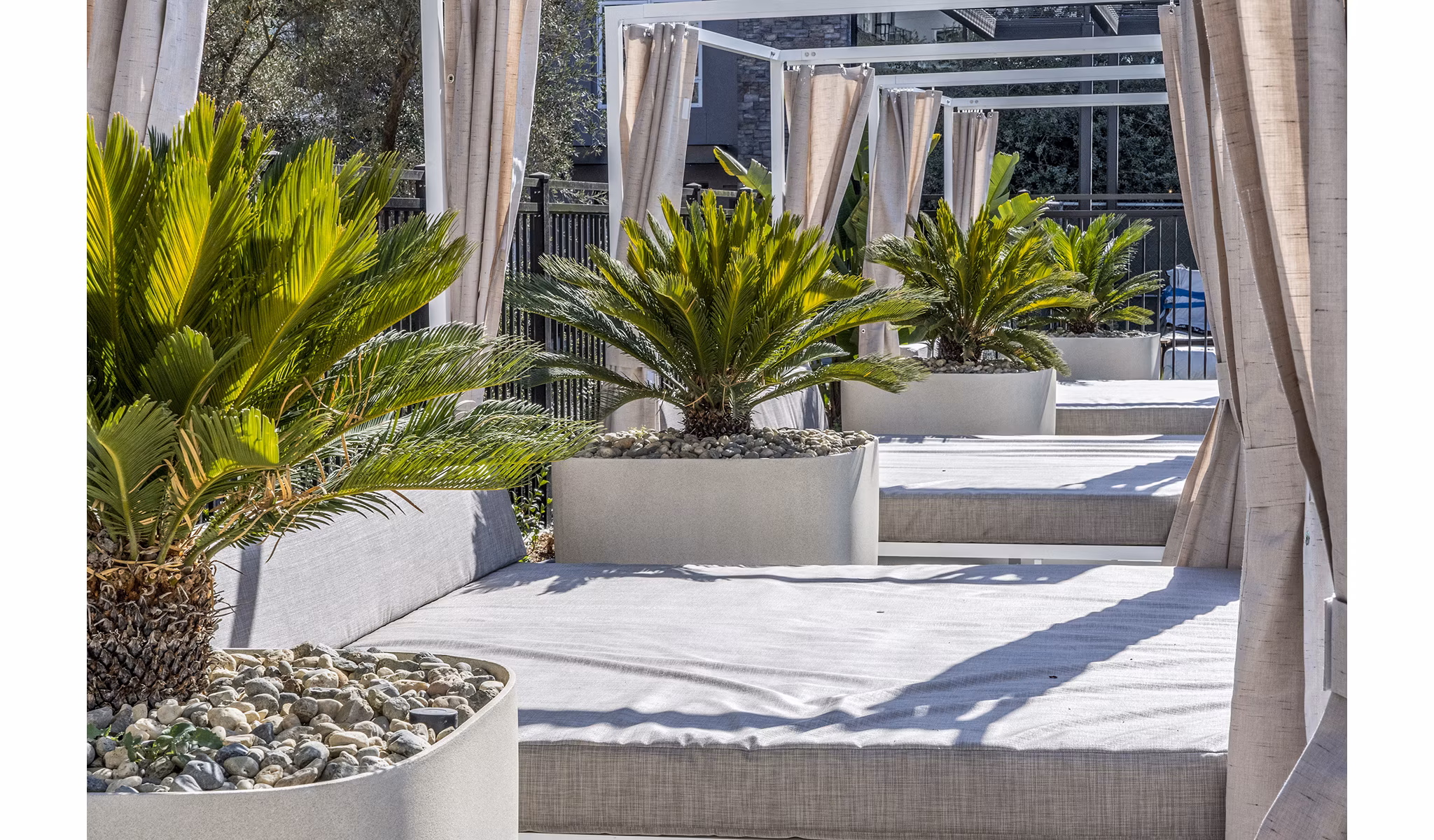 Spacious pool patio with lounge seating at The Asher Apartments offering luxury outdoor amenities in an elegant setting