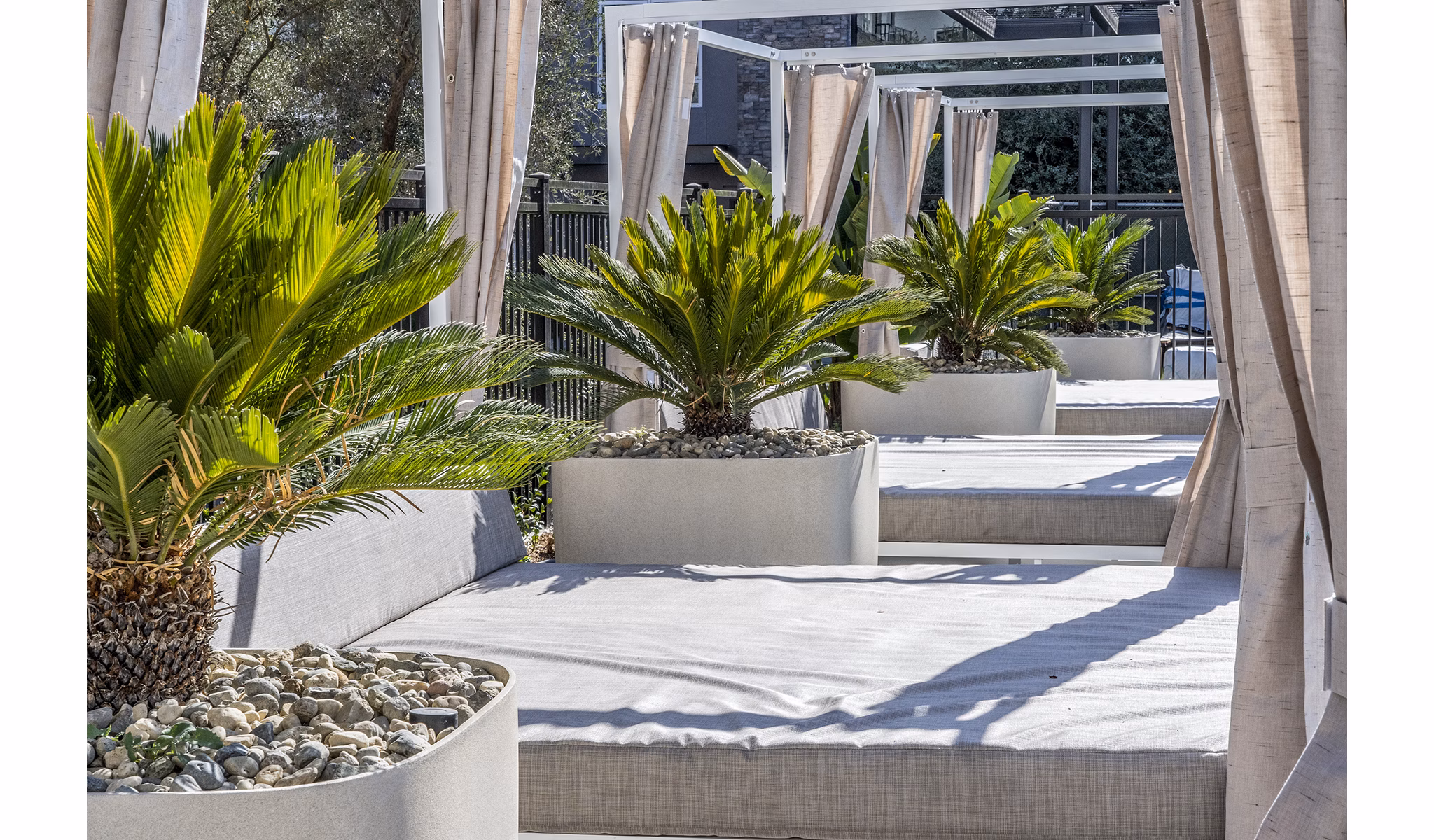 Spacious pool patio with lounge seating at The Asher Apartments offering luxury outdoor amenities in an elegant setting