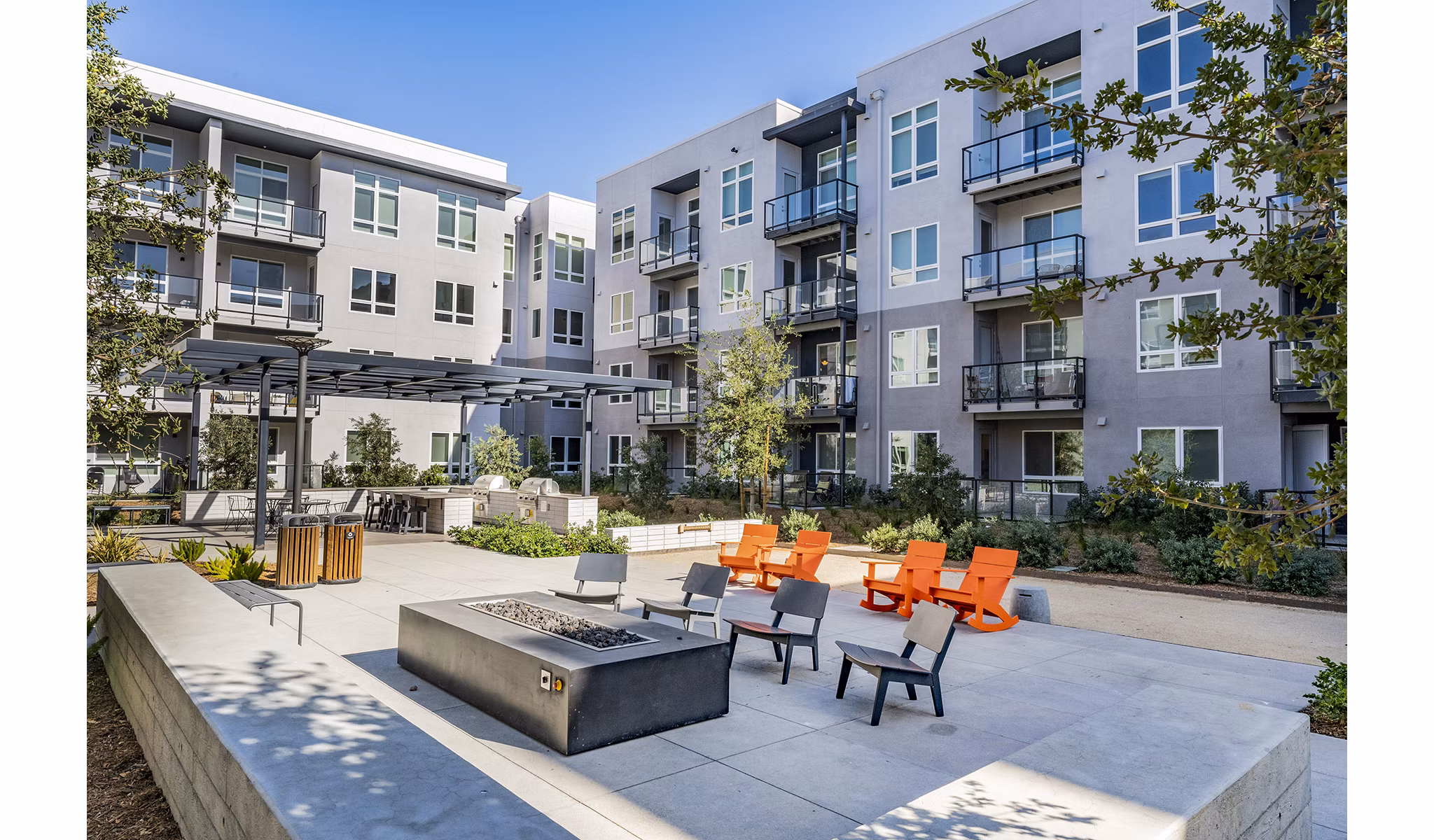 Cozy fire pit area at The Asher Apartments, perfect for social gatherings and relaxation in luxury living spaces