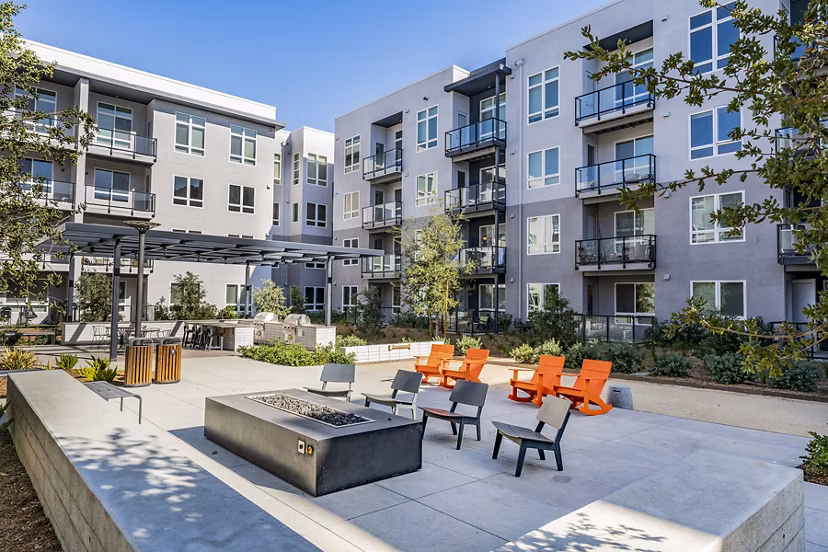 Cozy fire pit area at The Asher Apartments, perfect for social gatherings and relaxation in luxury living spaces
