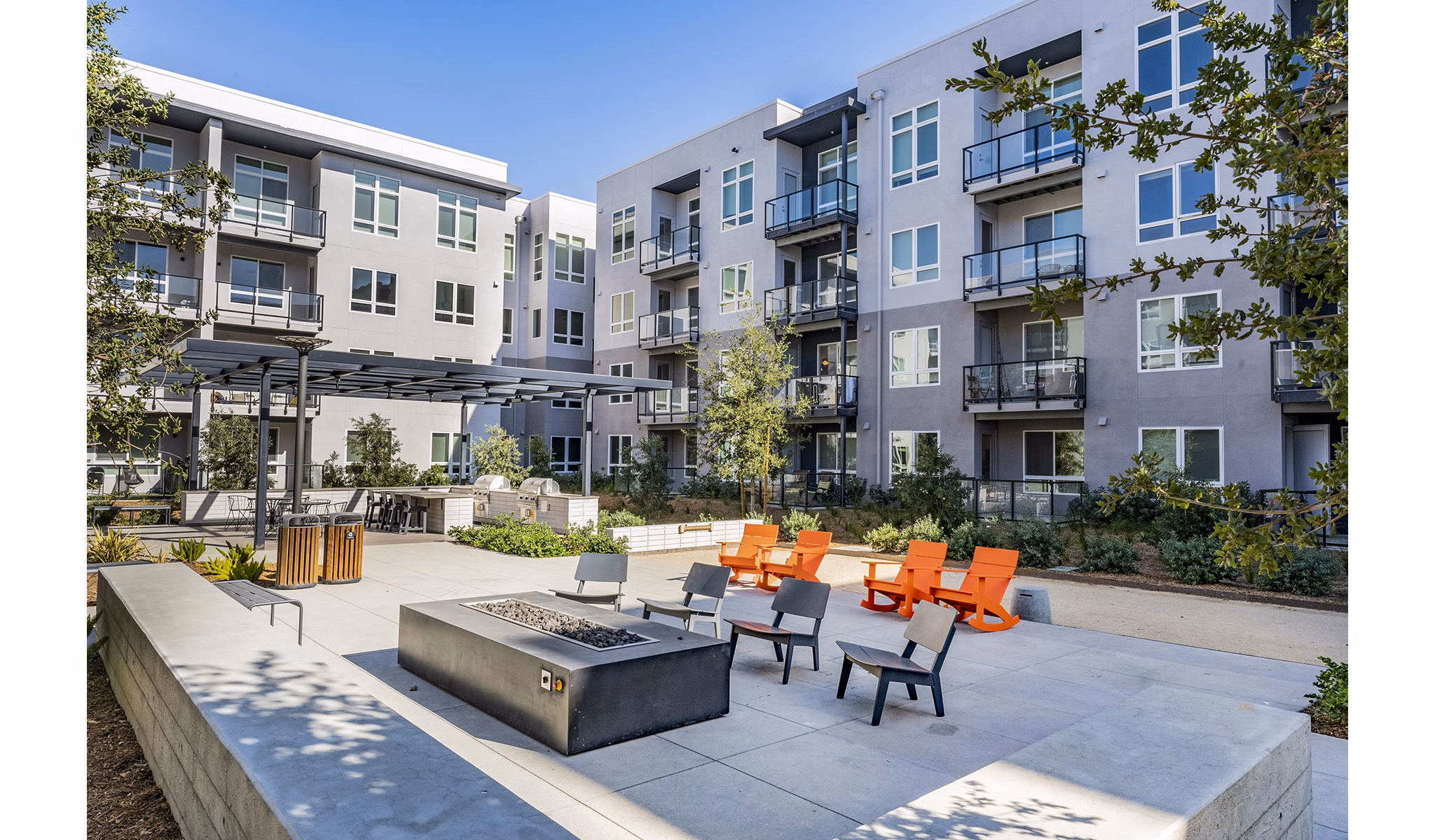 Cozy fire pit area at The Asher Apartments, perfect for social gatherings and relaxation in luxury living spaces