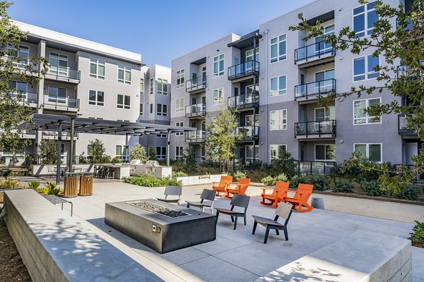 Cozy fire pit area at The Asher Apartments, perfect for social gatherings and relaxation in luxury living spaces