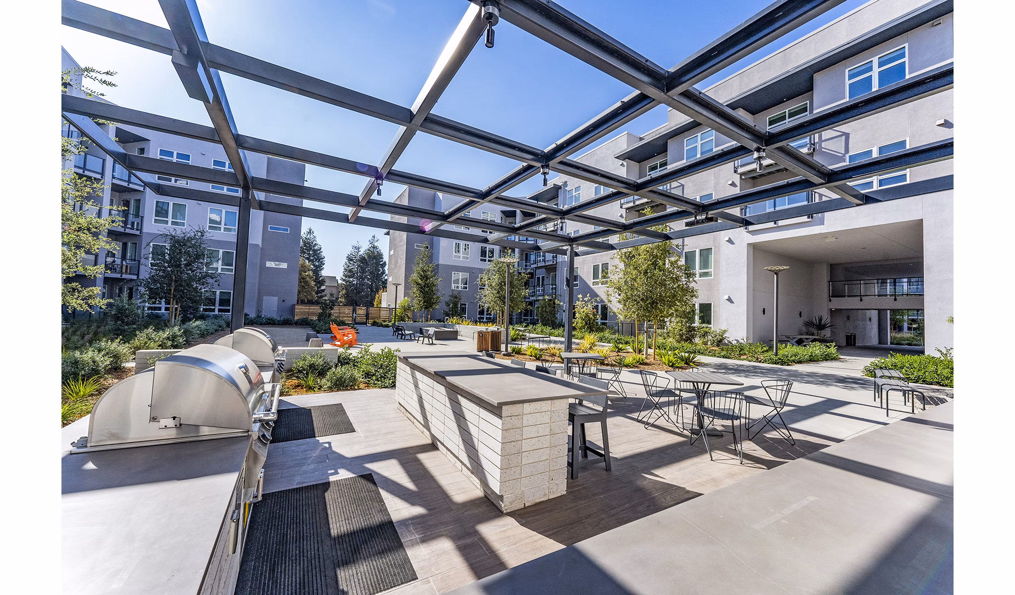 Grill area at The Asher Apartments: Outdoor BBQ space with modern facilities and seating perfect for gatherings