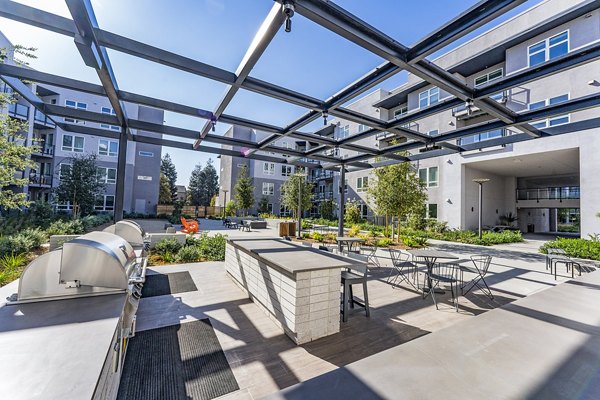 Grill area at The Asher Apartments: Outdoor BBQ space with modern facilities and seating perfect for gatherings