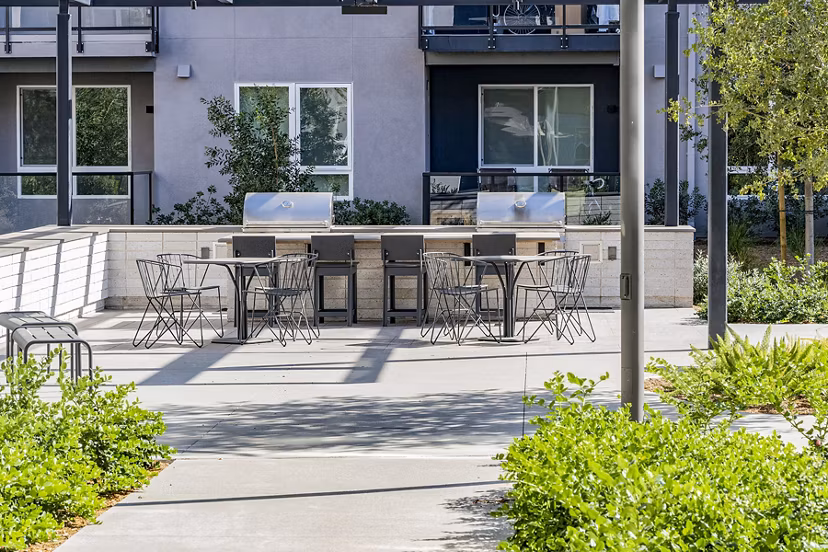 Outdoor grill area with modern setup at The Asher Apartments
