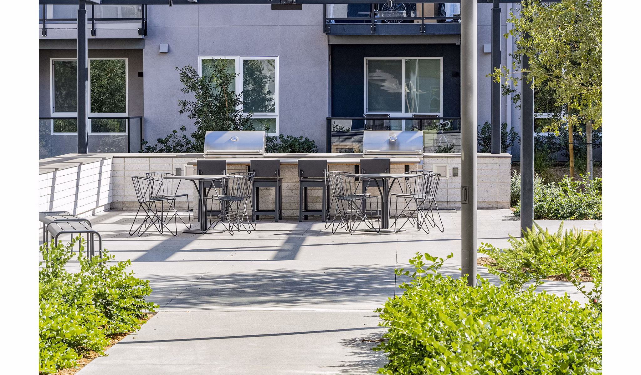 Outdoor grill area with modern setup at The Asher Apartments