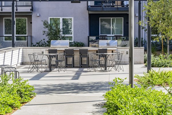 Outdoor grill area with modern setup at The Asher Apartments