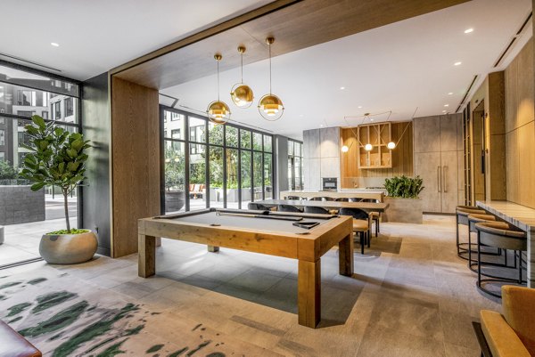 Modern game room featuring billiards and foosball at Atlas Apartments