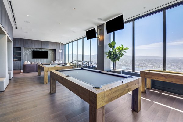 Game room with billiards table and modern seating in Atlas Apartments, offering luxury living and entertainment options in a vibrant community