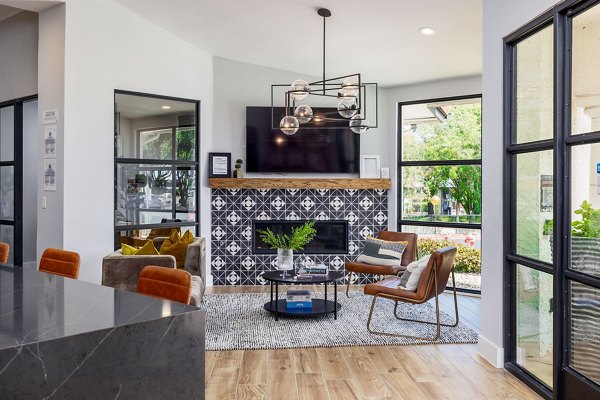 Mesa Verde Apartments: Elegant clubhouse featuring modern design and cozy seating areas in luxury Greystar community