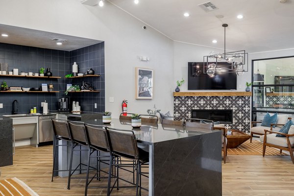 Clubhouse featuring modern design and seating areas at Mesa Verde Apartments