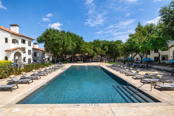 Relaxing outdoor pool area with lounge chairs at Mesa Verde Apartments