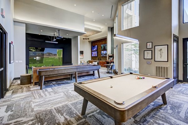 Game room with pool table and arcade games at Lenox Reserve Apartments providing entertainment and relaxation in luxury living spaces