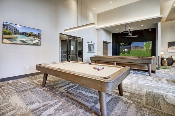 Game room with pool table and lounge seating at Lenox Reserve Apartments offering luxury amenities