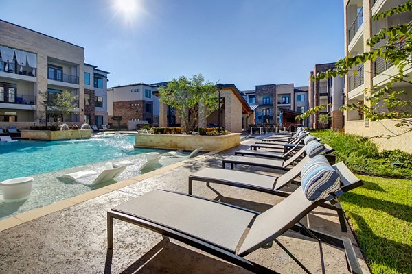 Luxurious pool area at Lenox Reserve Apartments featuring comfortable lounge seating and serene water views