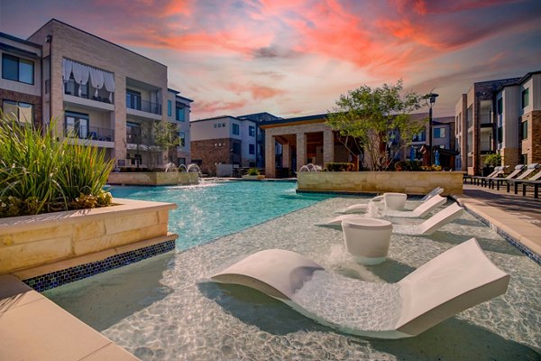 Luxury pool with landscaped surroundings at Lenox Reserve Apartments