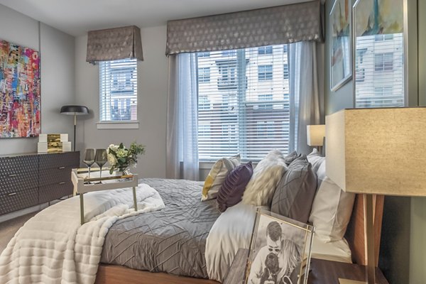 Cozy bedroom with natural light at Bainbridge South End Apartments in Greystar's luxury collection