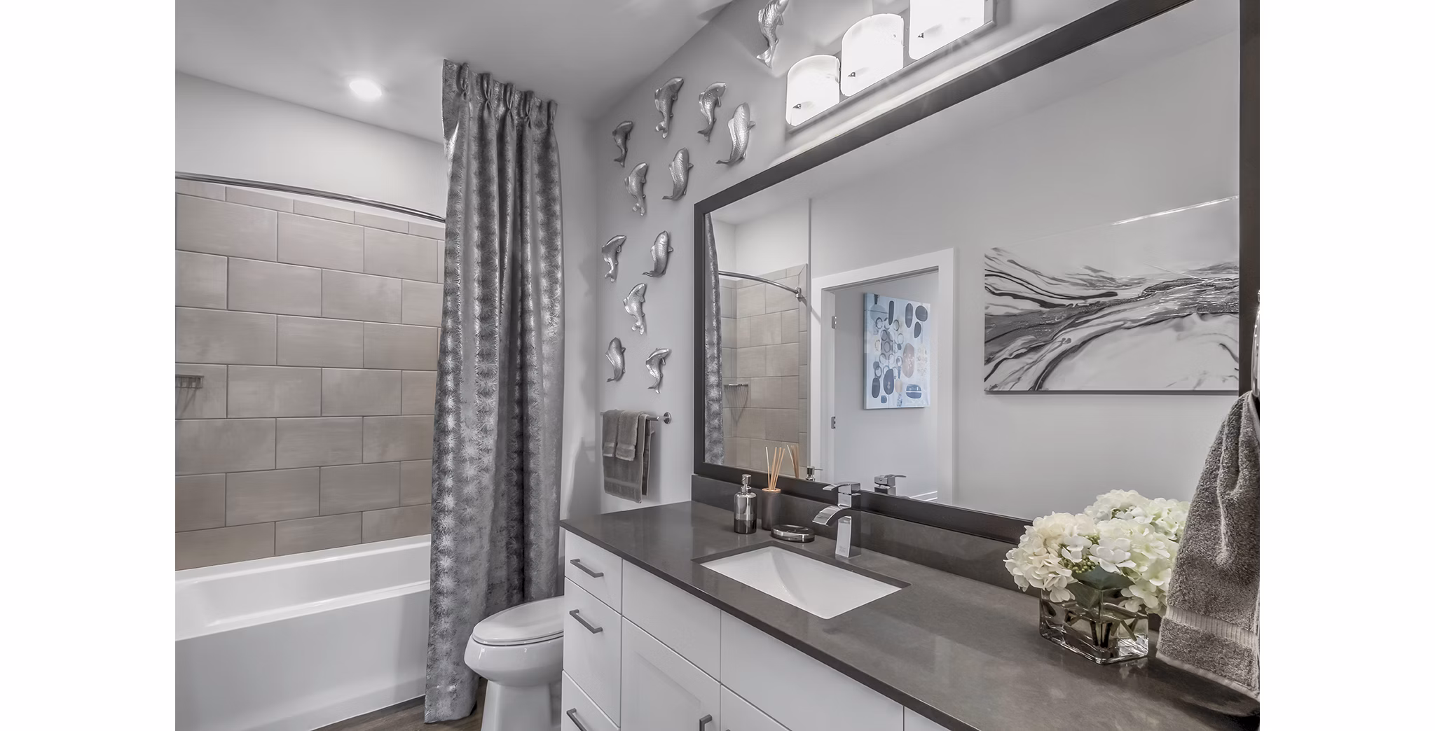 Bathroom with modern fixtures and elegant design at Bainbridge South End Apartments; featuring spacious layout and luxurious finishes for a relaxing experience