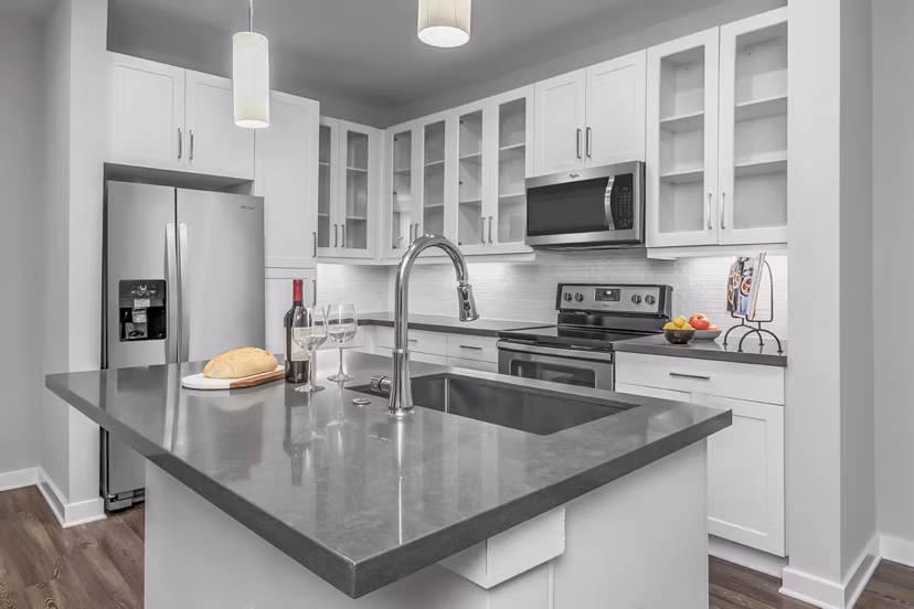 Modern kitchen with stainless steel appliances at Bainbridge South End Apartments, a Greystar luxury community