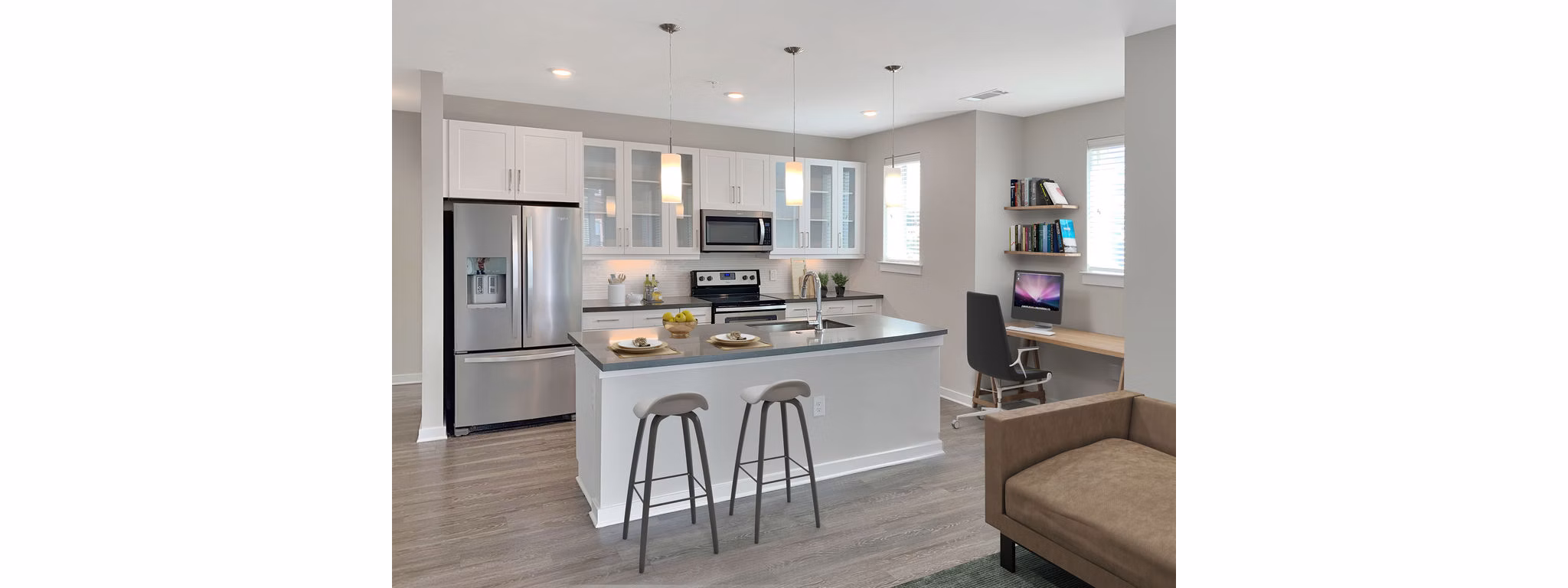 Modern kitchen with stainless steel appliances at Maddox South End Apartments