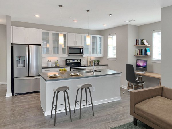 Modern kitchen with stainless steel appliances at Maddox South End Apartments