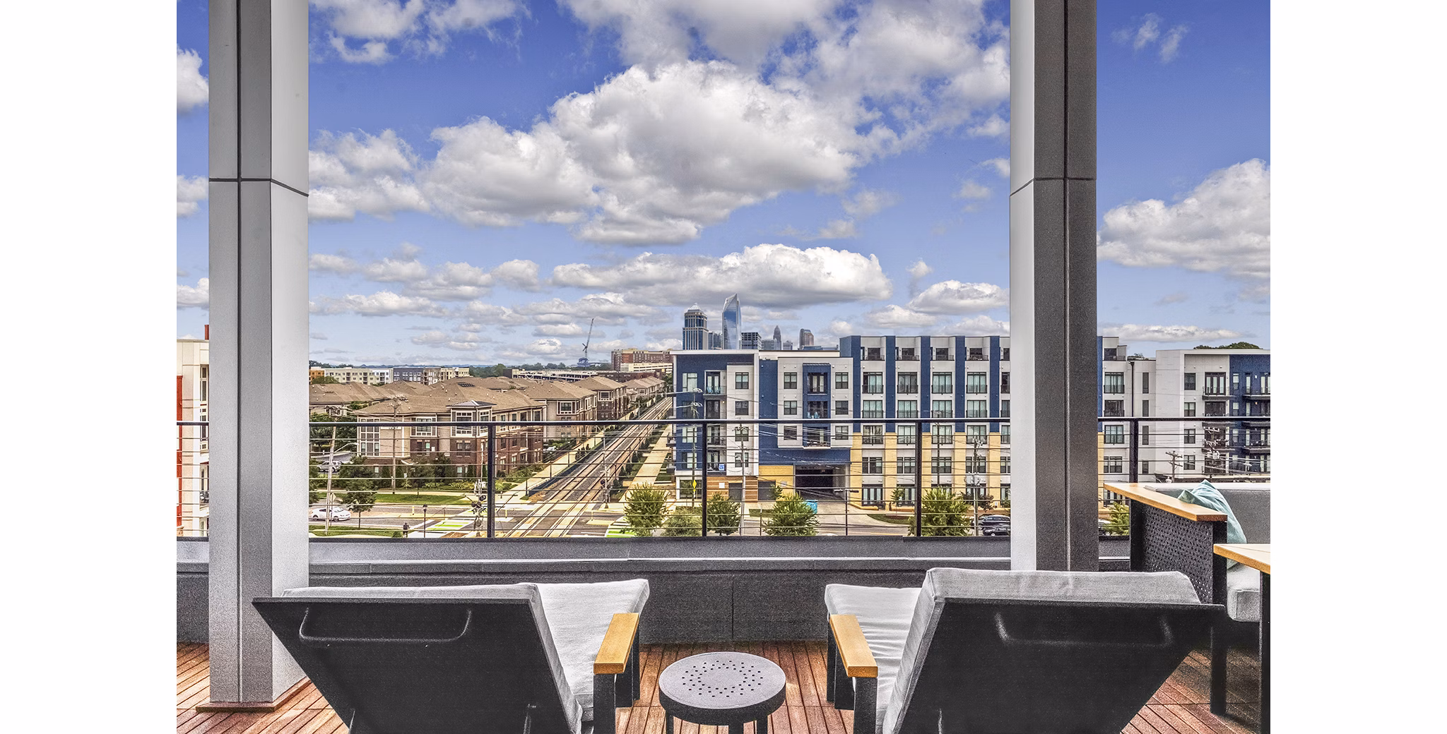 Spacious rooftop deck at Bainbridge South End Apartments with city views, perfect for relaxation and gatherings