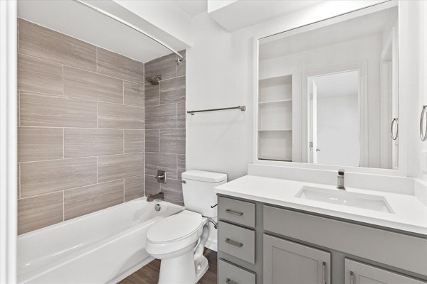 Modern bathroom with double vanity and marble accents at The Haven Apartments