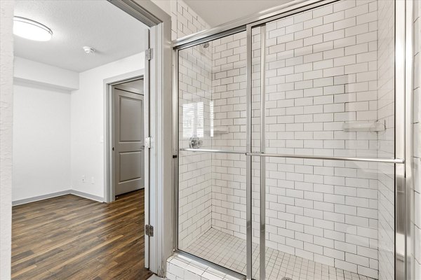 Modern bathroom with sleek fixtures and a glass shower in The Haven Apartments