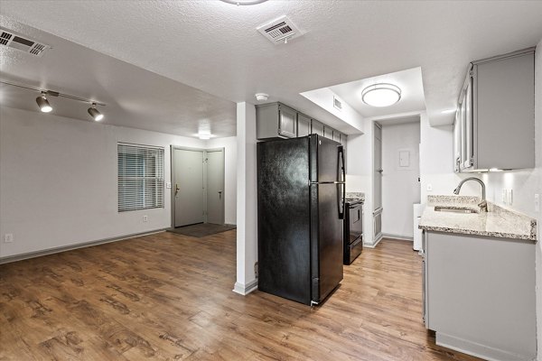 Modern kitchen with stainless steel appliances and quartz countertops in The Haven Apartments