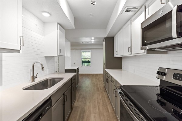 Modern kitchen with stainless steel appliances at The Haven Apartments in a Greystar luxury community