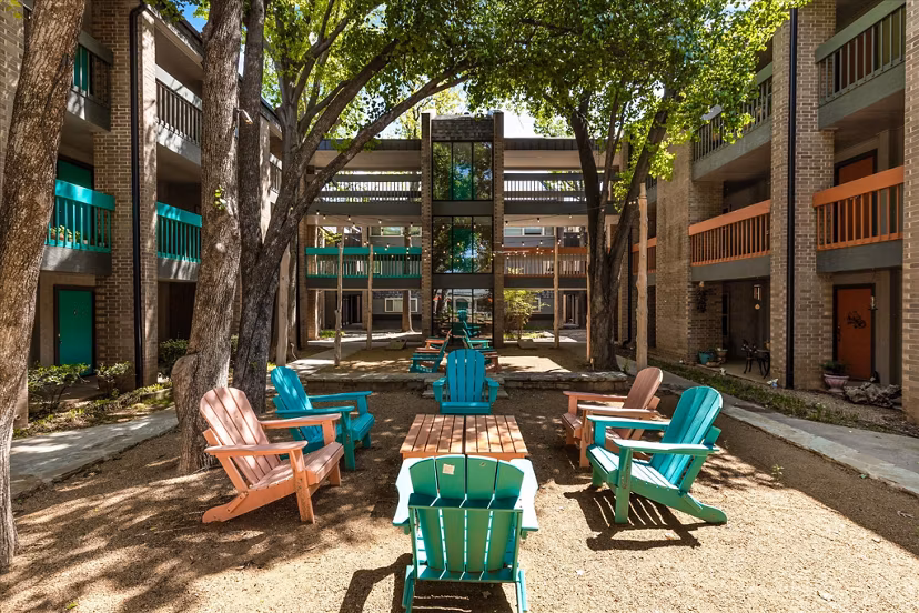 Courtyard with lush greenery and seating areas at The Haven Apartments