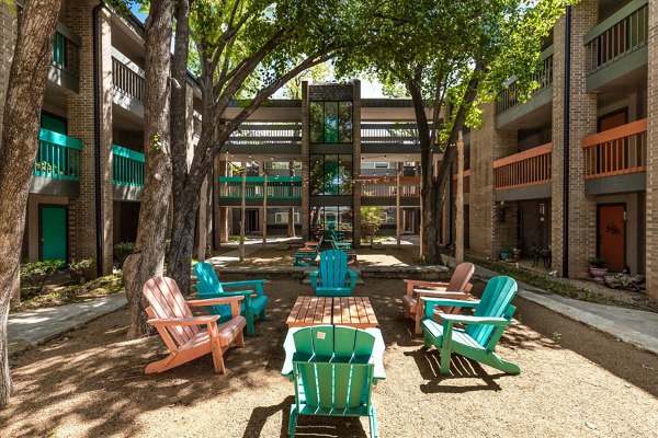 Courtyard with lush greenery and seating areas at The Haven Apartments