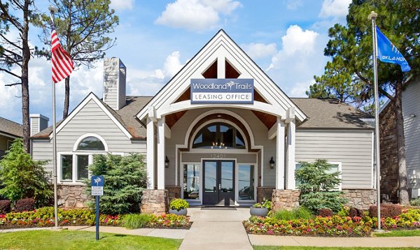Woodland Trails Apartments: Stunning of luxury apartment complex surrounded by lush greenery in a serene setting