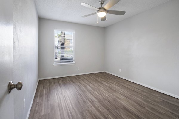 Cozy bedroom with natural light at Woodland Trails Apartments, featuring luxury furnishings for a tranquil living experience