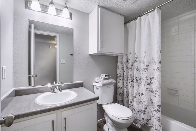 Bathroom at Woodland Trails Apartments featuring modern fixtures and elegant design