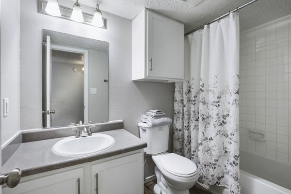 Bathroom at Woodland Trails Apartments featuring modern fixtures and elegant design