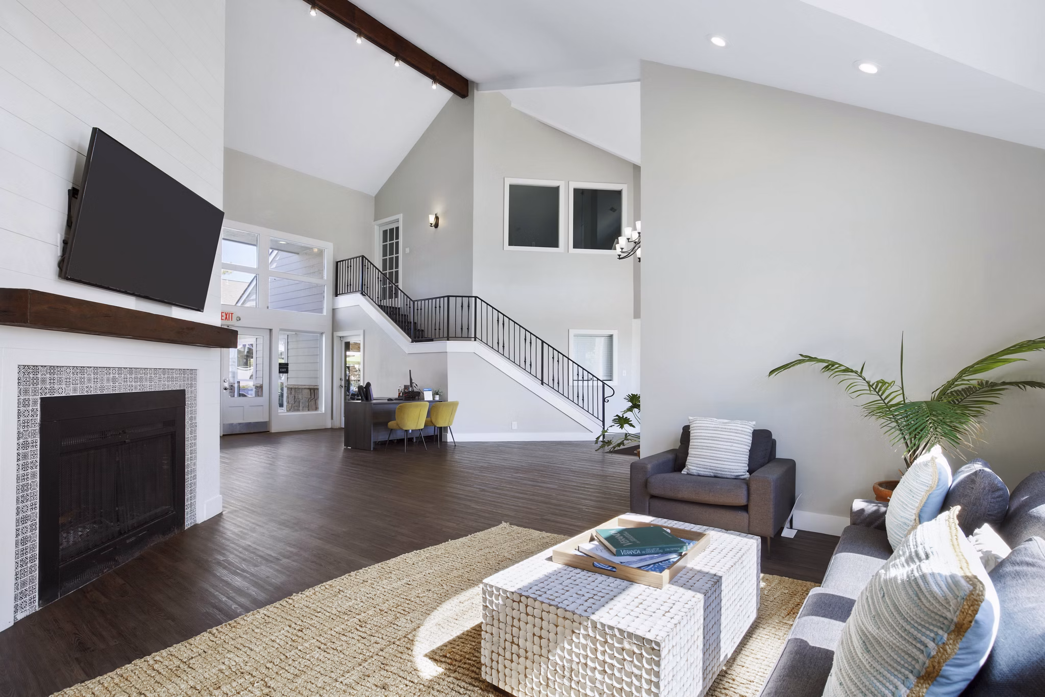Woodland Trails Apartments: Modern clubhouse with spacious seating and large windows ideal for social gatherings in a serene setting