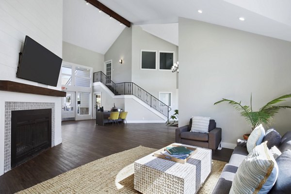 Woodland Trails Apartments: Modern clubhouse with spacious seating and large windows ideal for social gatherings in a serene setting
