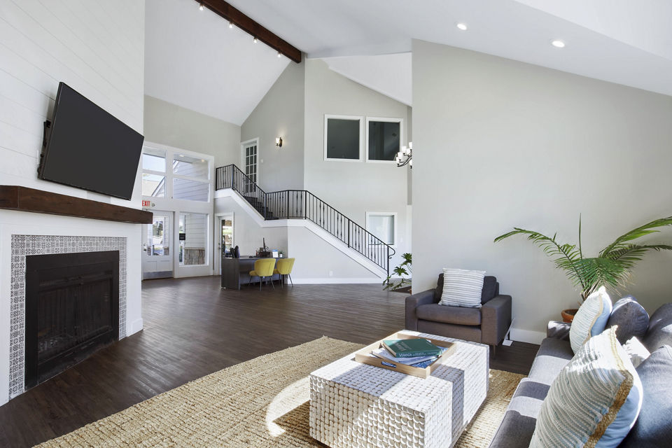 Woodland Trails Apartments: Modern clubhouse with spacious seating and large windows ideal for social gatherings in a serene setting