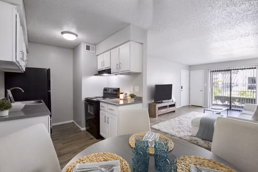 Dining area with modern furnishings and natural light at Woodland Trails Apartments