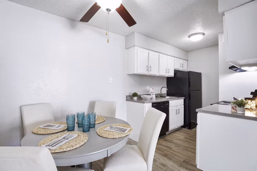 Dining area featuring modern furnishings and a large window at Woodland Trails Apartments