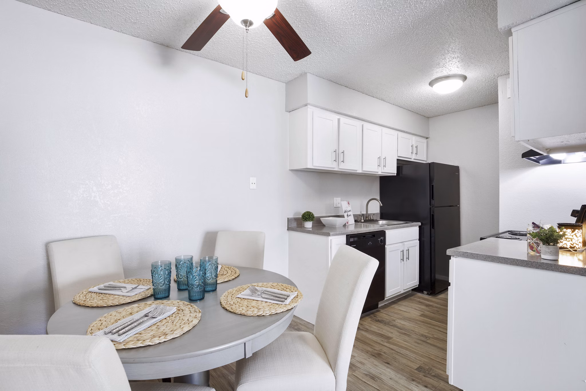 Dining area featuring modern furnishings and a large window at Woodland Trails Apartments