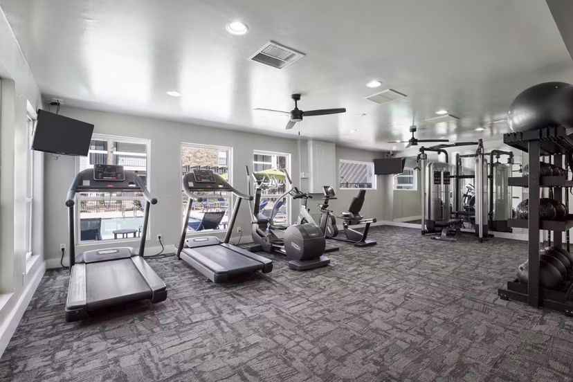 State-of-the-art fitness center at Woodland Trails Apartments equipped with modern exercise machines and free weights for a comprehensive workout