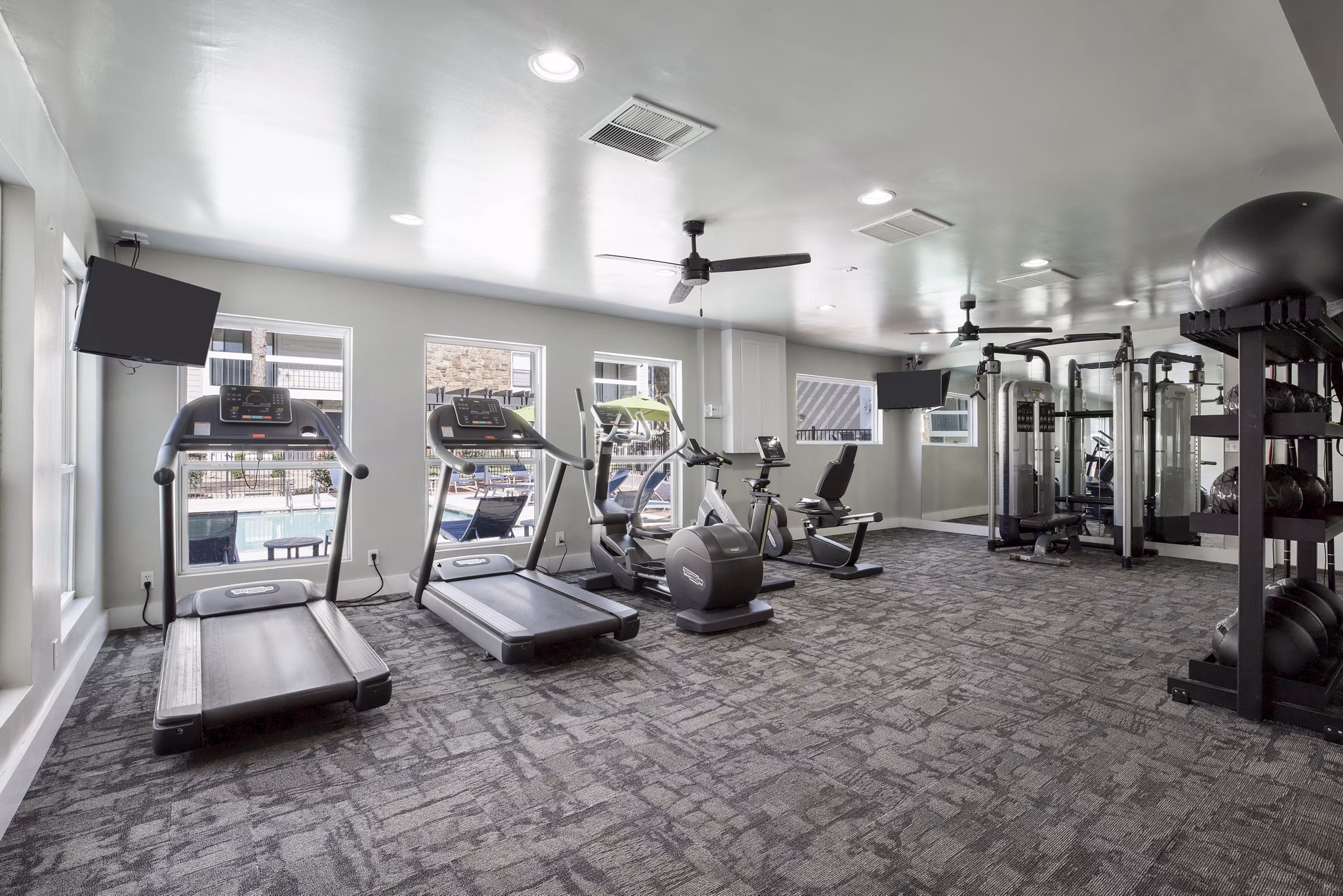 State-of-the-art fitness center at Woodland Trails Apartments equipped with modern exercise machines and free weights for a comprehensive workout